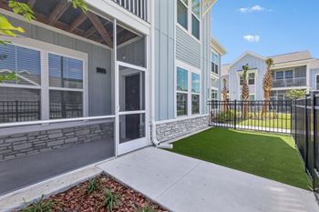 A modern house with a white exterior and a black fence at The Junction at Rockledge Apartments, Florida, 32955